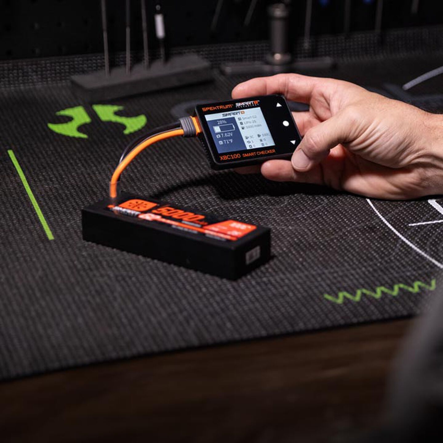 Person holding a spektrum battery checker. Shop the RC parts and accessories category.